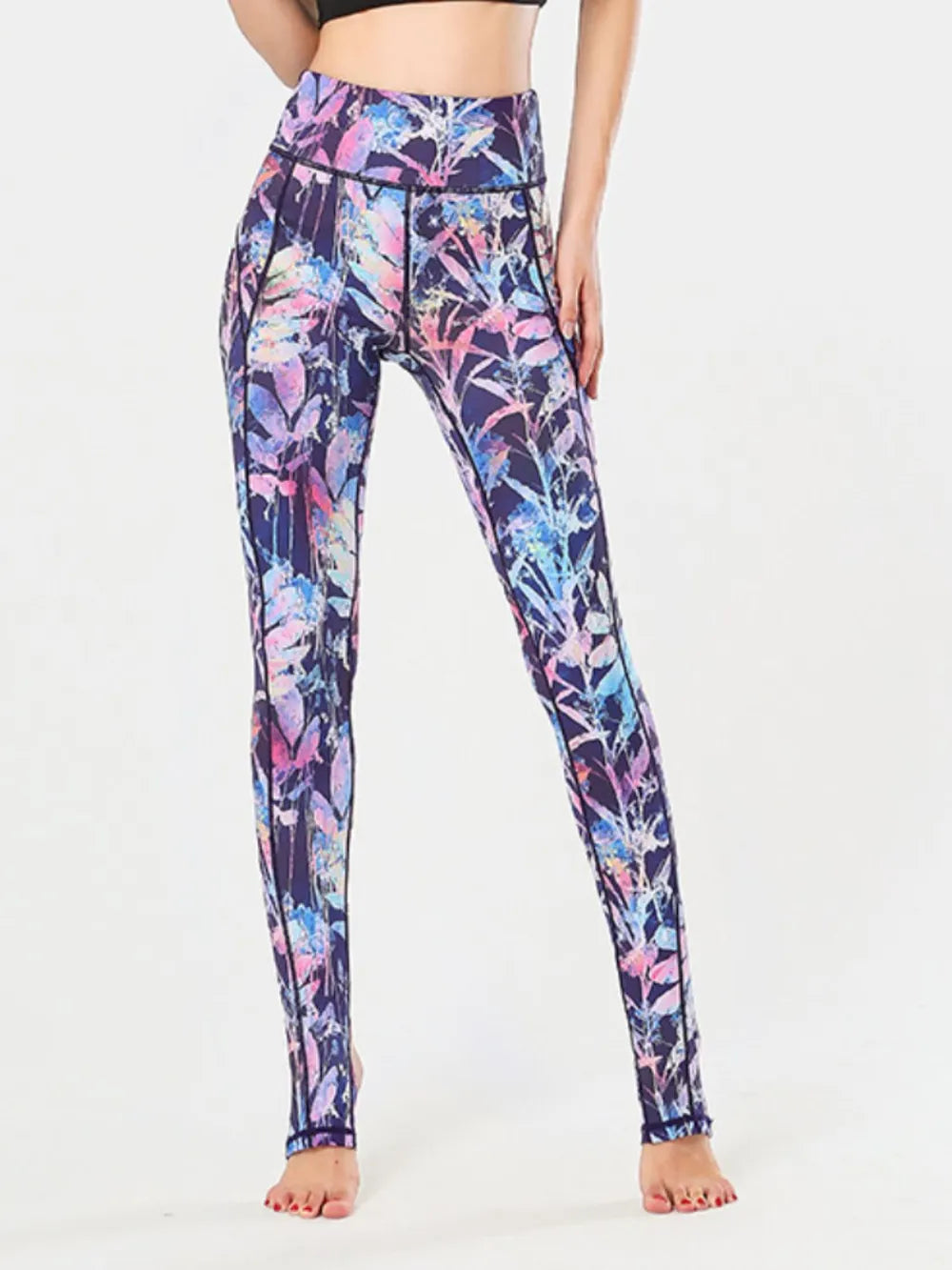 NEWYORKLISTED ACTIVEWEAR COLLECTION: Multicolored floral leggings worn by a person on a white background