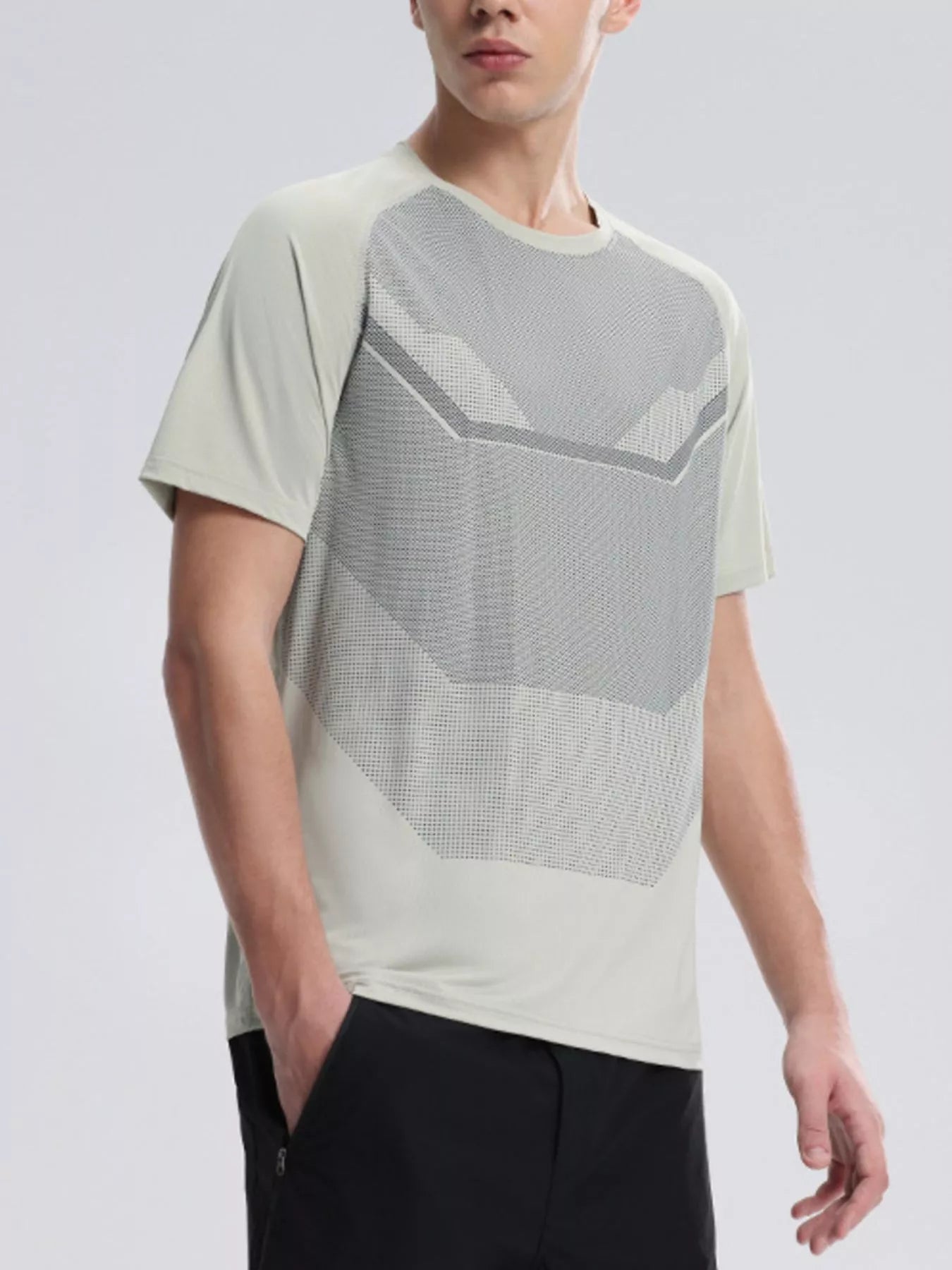 NEWYORKLISTED ATLAS MEN'S COLLECTION: Person wearing a modern, light-colored t-shirt with geometric patterns on a plain background
