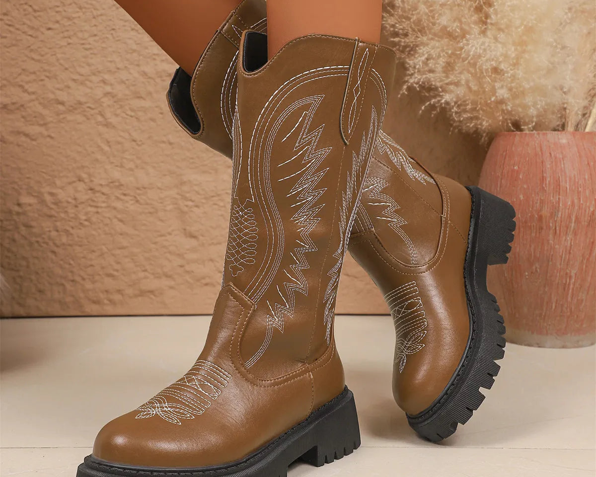 NEWYORKLISTED SHOE COLLECTION: Round Toe Block Heels Boots: Brown cowboy boots with detailed stitching on a neutral background