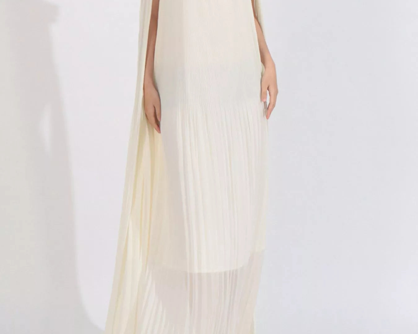 NEWYORKLISTED STYLE COLLECTION: Woman wearing a white off-shoulder dress with floral details on a white background