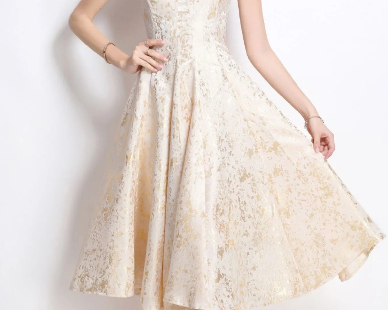 NEWYORKLISTED STYLE COLLECTION: Woman wearing a white lace dress against a plain background
