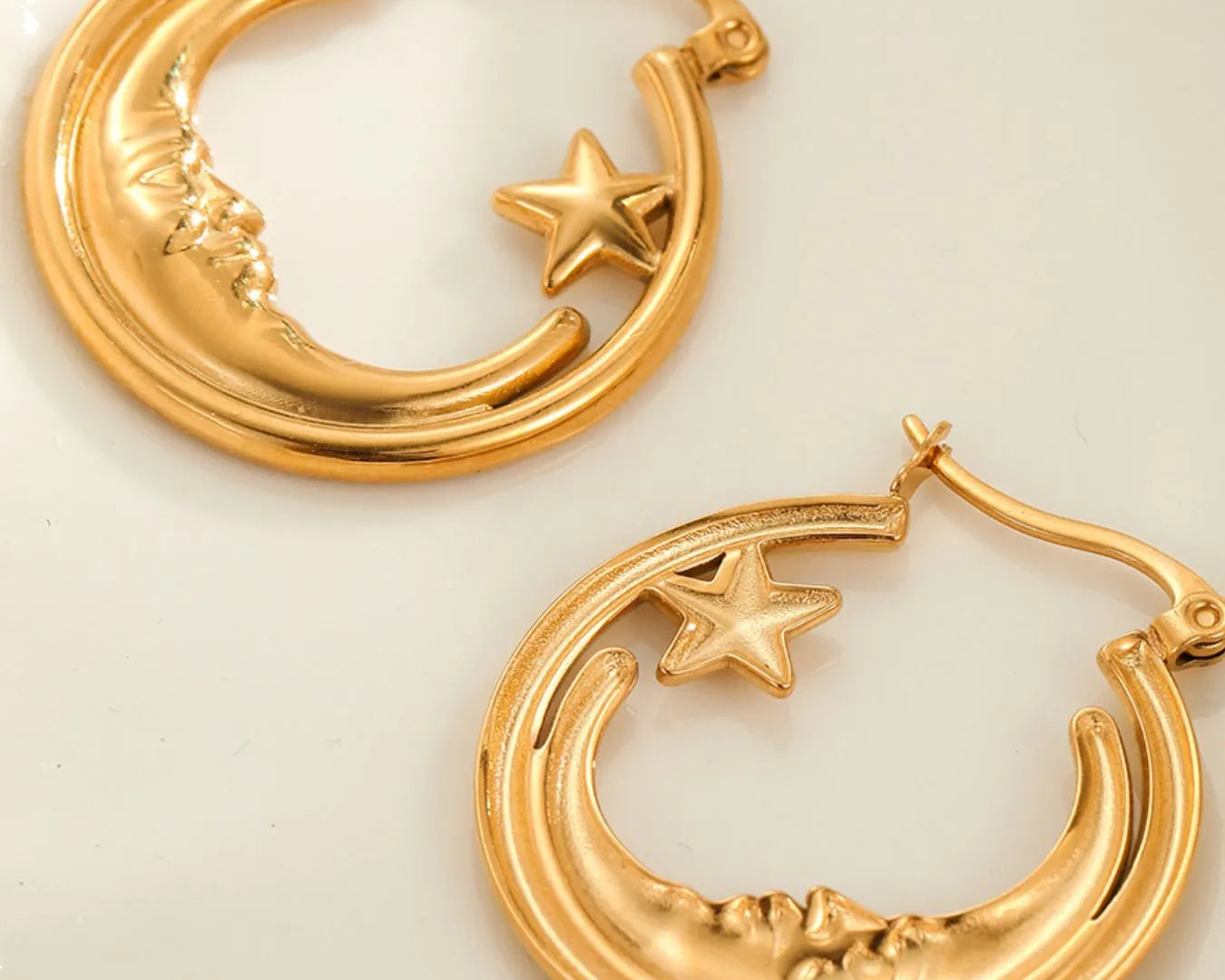 Gold hoop earrings with star and crescent moon designs on a light background: NEWYORKLISTED STYLE COLLECTION