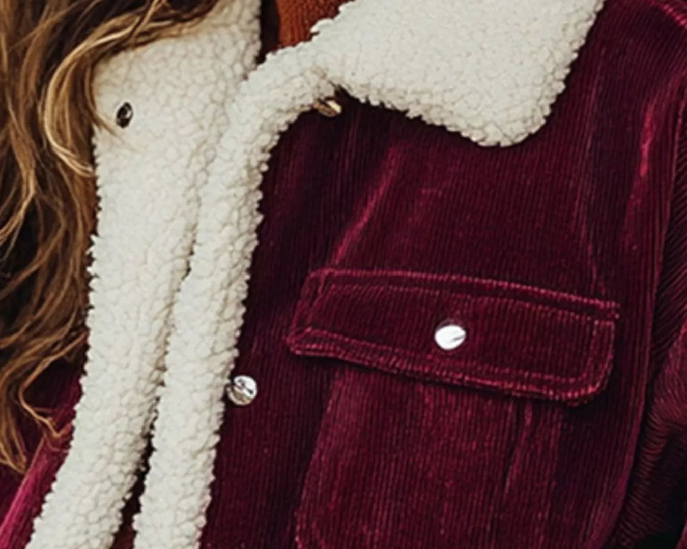 NEWYORKLISTED STYLE COLLECTION: Close-up of a burgundy corduroy jacket with white sherpa lining
