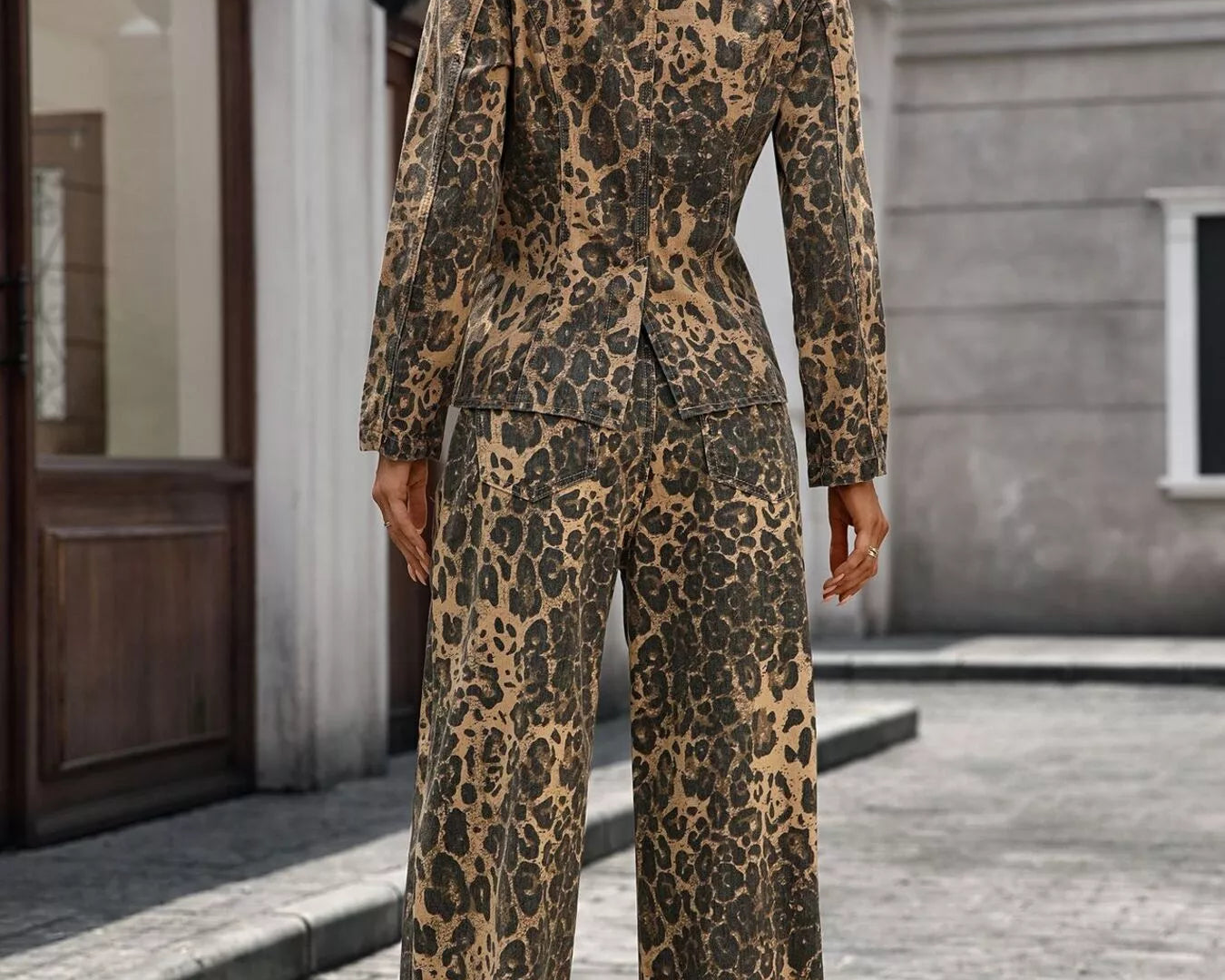 NEWYORKLISTED STYLE COLLECTION: Person wearing a leopard print outfit standing on a street.