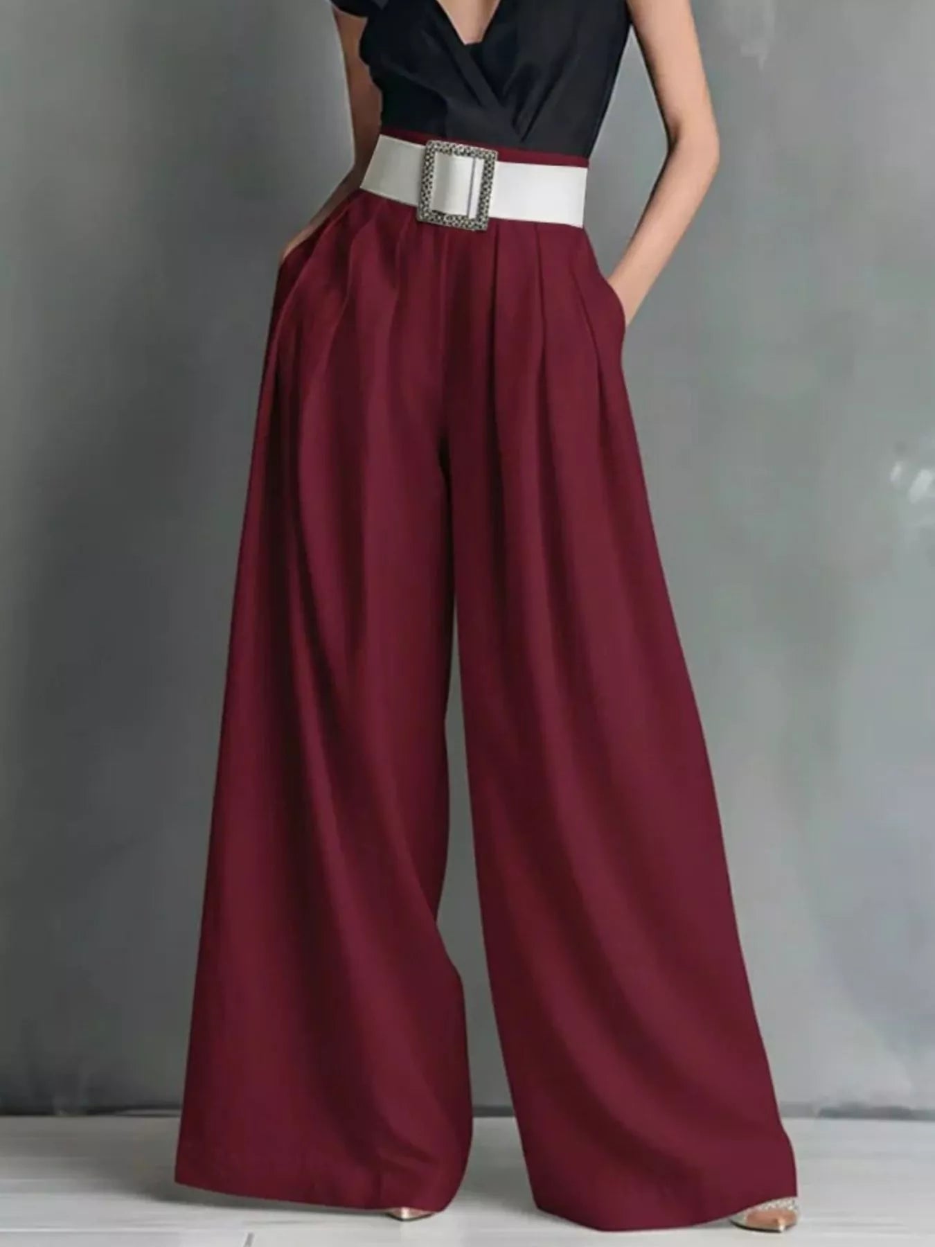 NEWYORKLISTED STYLE COLLECTION: Maroon wide-leg pants with a black top and white belt on a gray background