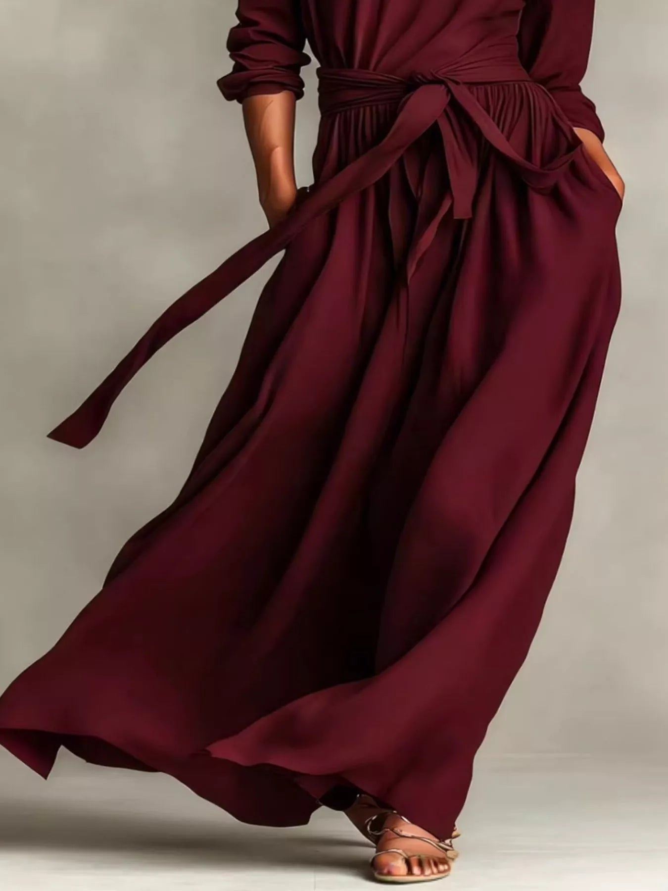 NEWYORKLISTED STYLE COLLECTION: Maroon wrap dress with a belt on a neutral background
