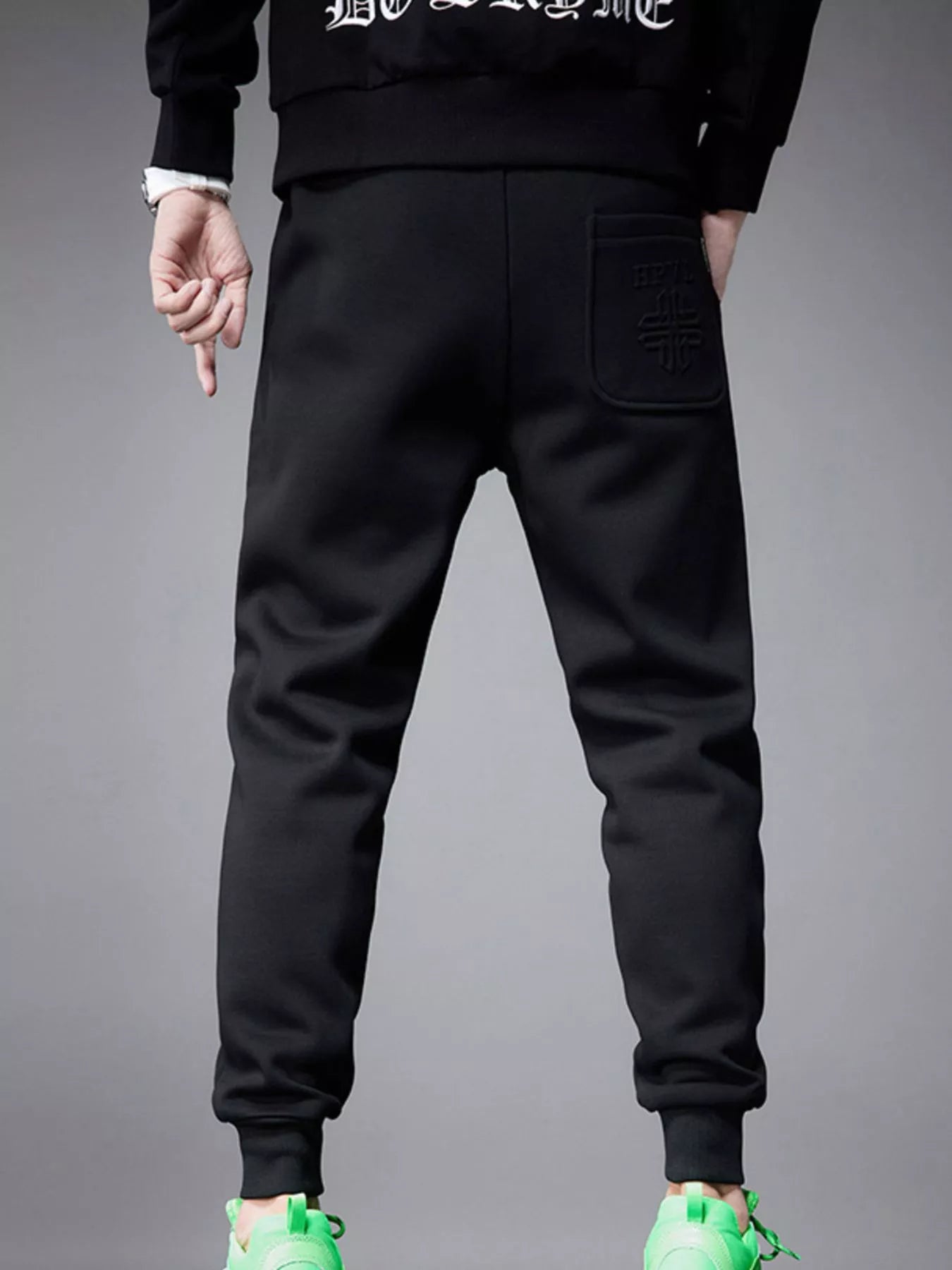 NEWYORKLISTED ATLAS MEN's COLLECTION: Black jogger pants worn by a person on a gray background