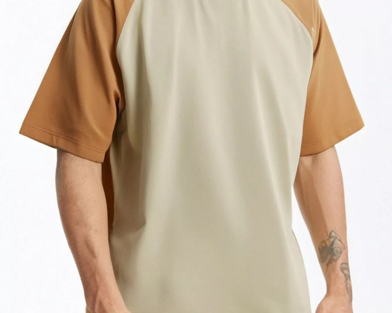 NEWYORKLISTED ATLAS MEN's COLLECTION: Man wearing a beige and brown baseball shirt with yellow pants on a white background