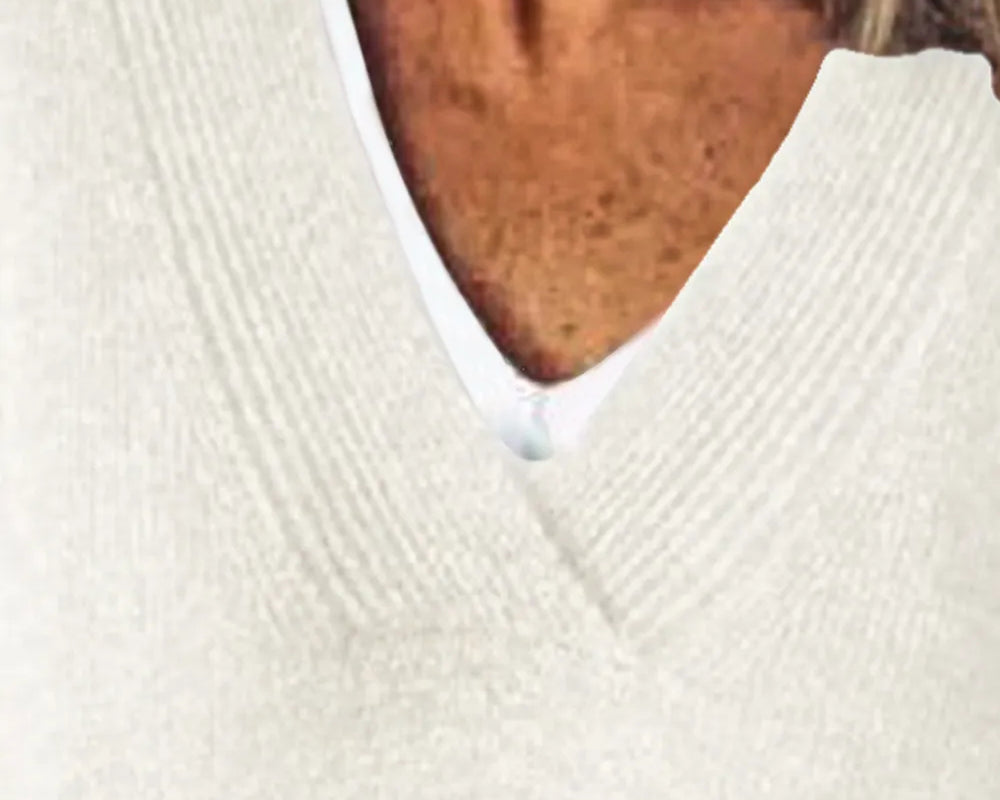 NEWYORKLISTED STYLE COLLECTION: Close-up of a person wearing a white sweater with a blurred background