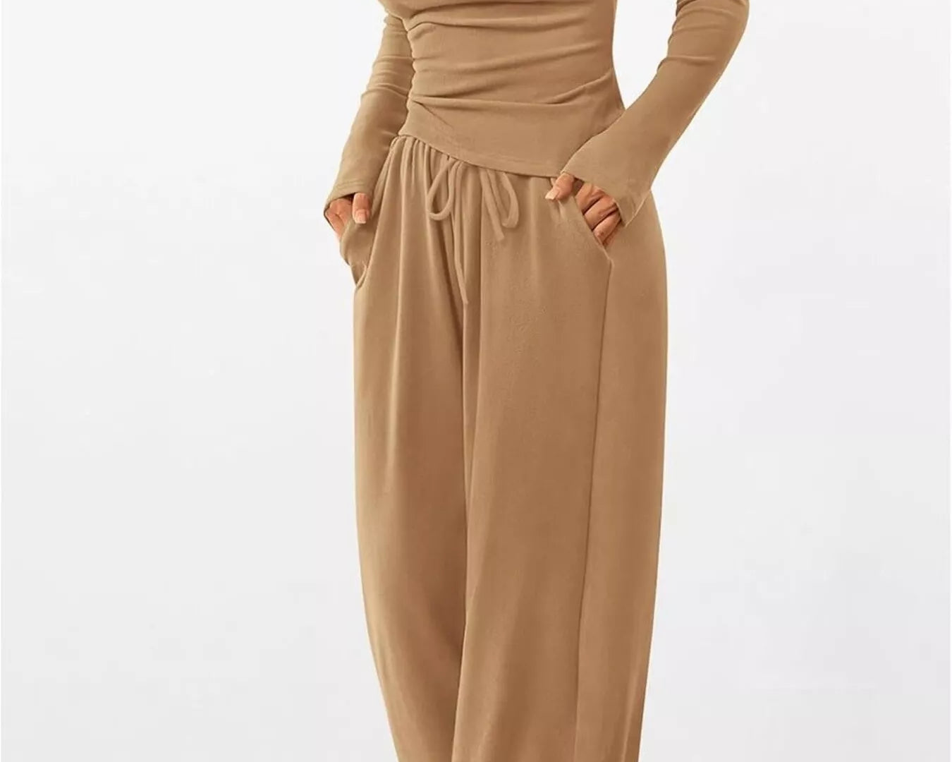 Beige jumpsuit with long sleeves and wide-leg pants on a white background