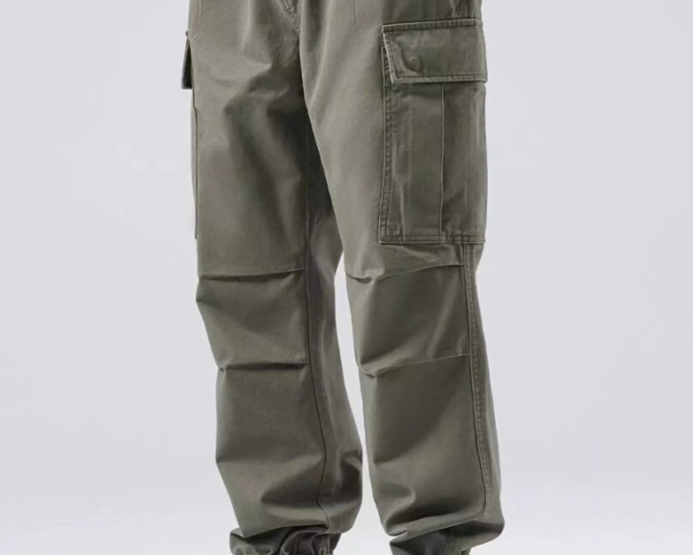 NEWYORKLISTED ATLAS MEN'S COLLECTION: Person wearing olive green cargo pants with a plain background