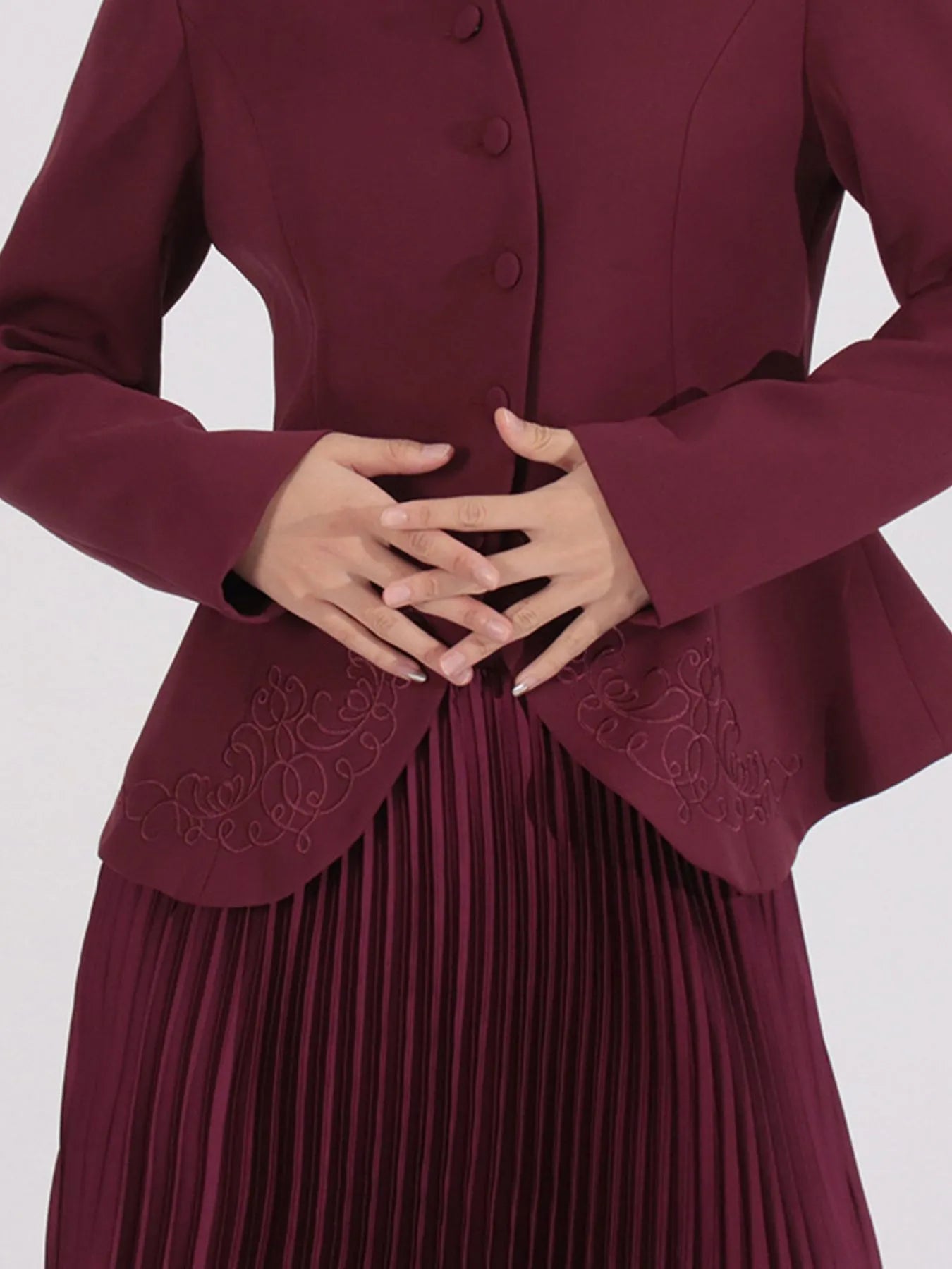NEWYORKLISTED STYLE COLLECTION: Maroon dress with intricate detailing on a white background