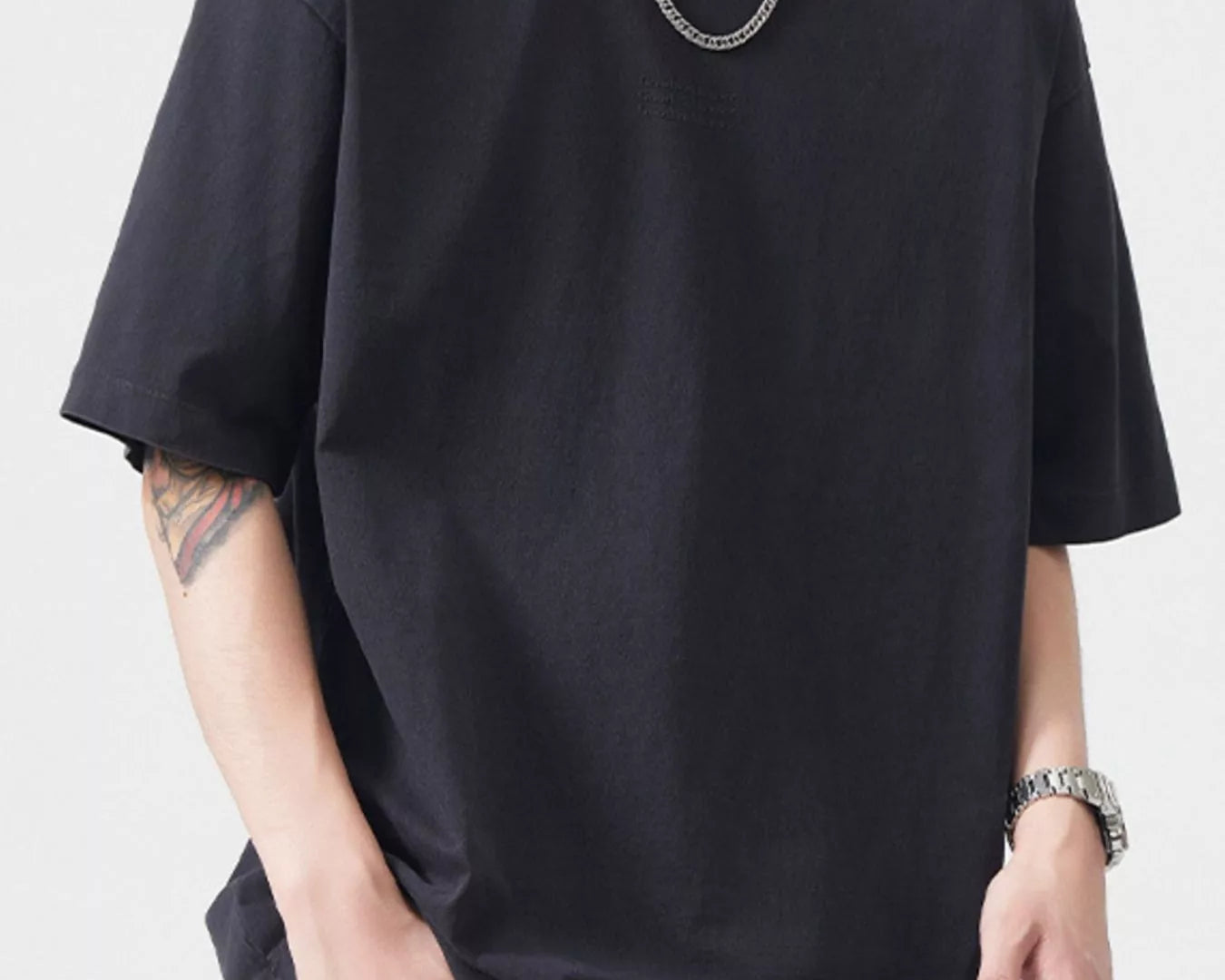 NEWYORKLISTED ATLAS MEN's COLLECTION: Person wearing a black t-shirt and jeans with a plain background