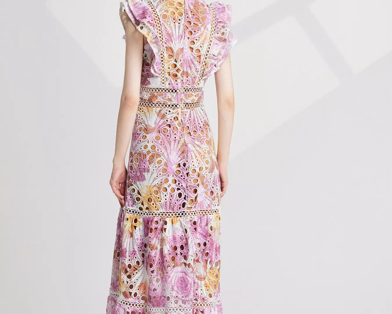 NEWYORKLISTED STYLE COLLECTION: Woman wearing a floral dress on a white background