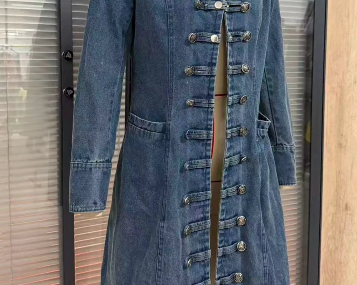 NEWYORKLISTED STYLE COLLECTION – Women's long blue denim military-inspired coat featuring a notched lapel collar, decorative silver-tone buttons, double-breasted styling, long sleeves, front pockets, and a tailored silhouette with a flared hem.