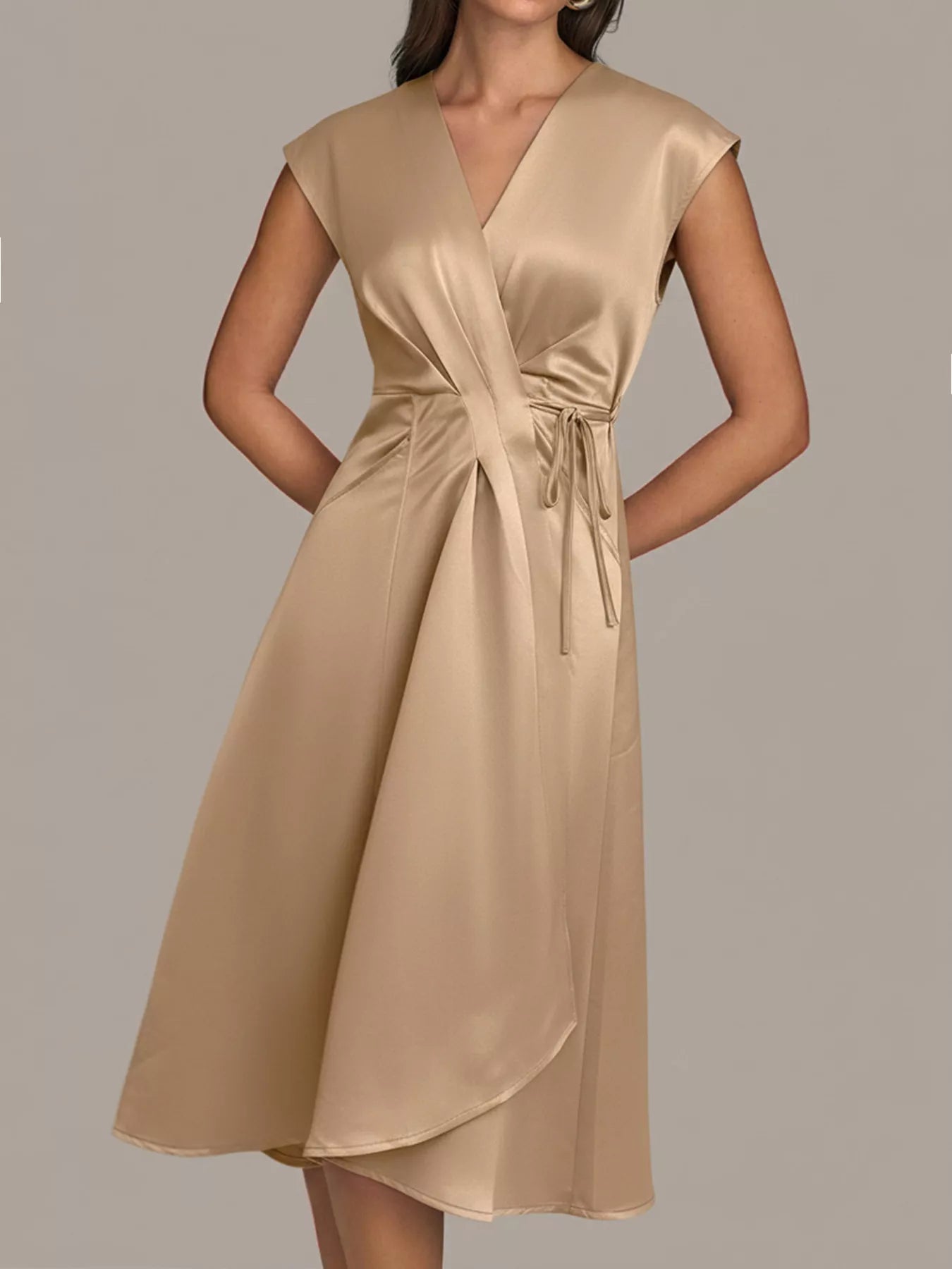 NEWYORKLISTED RUNWAY STYLE: Beige dress worn by a model on a plain background