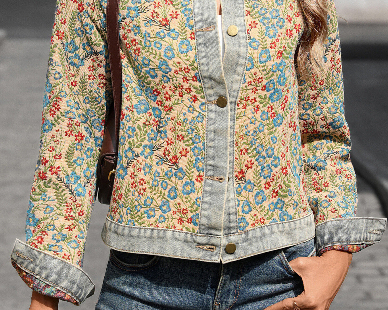NEWYORKLISTED STYLE COLLECTION: Person wearing a floral denim jacket and jeans, holding a coffee cup.