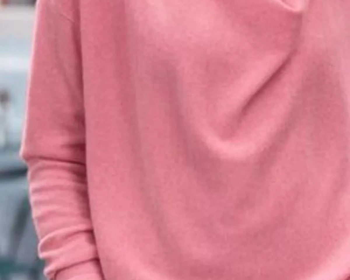 NEWYORKLISTED STYLE COLLECTION: Person wearing a pink sweater with a blurred background