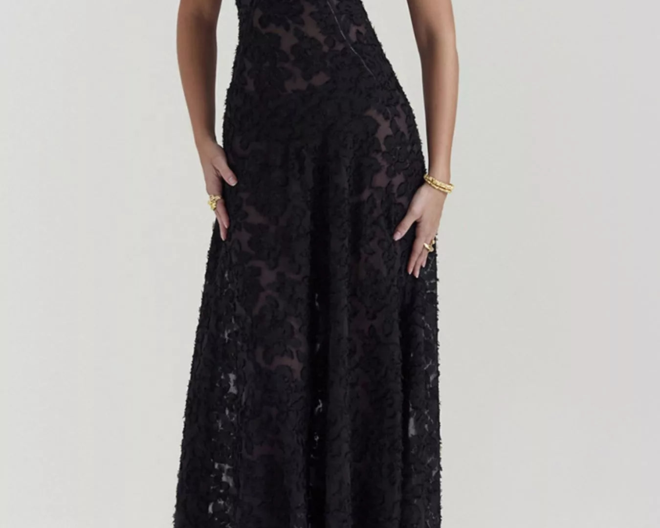 NEWYORKLISTED STYLE COLLECTION: Black lace dress worn by a model on a white background