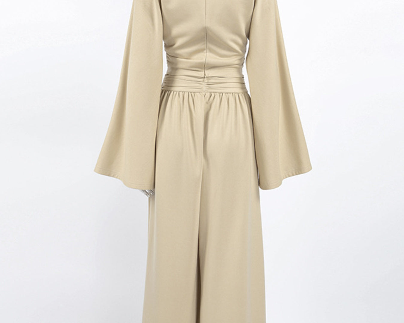 NEWYORKLISTED STYLE COLLECTION: Beige dress with long sleeves on a mannequin against a white background