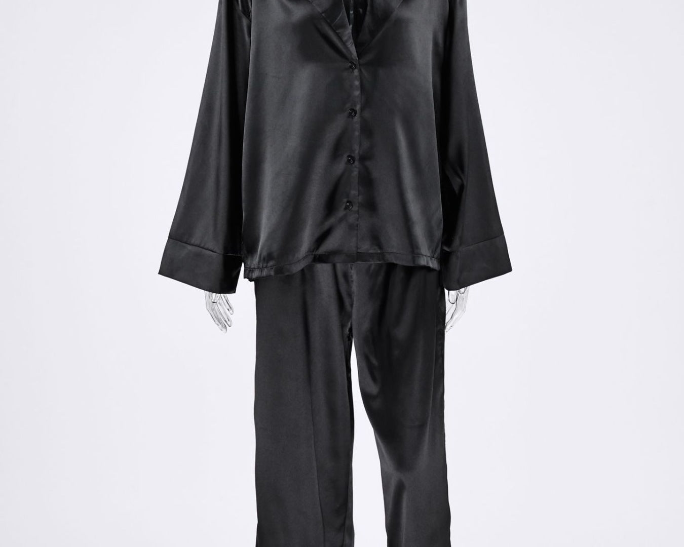 NEWYORKLISTED Intimate Apparel Collection: Black satin pajama set on a mannequin against a white background