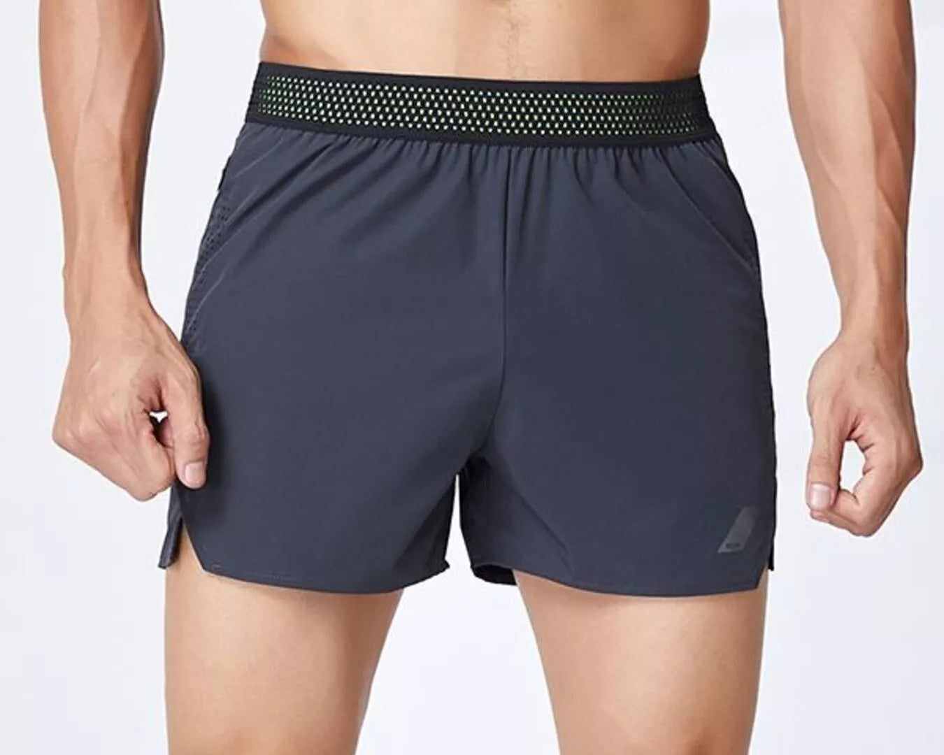 NEWYORKLISTED ATLAS MEN's COLLECTION: Man wearing dark gray athletic shorts with a white background