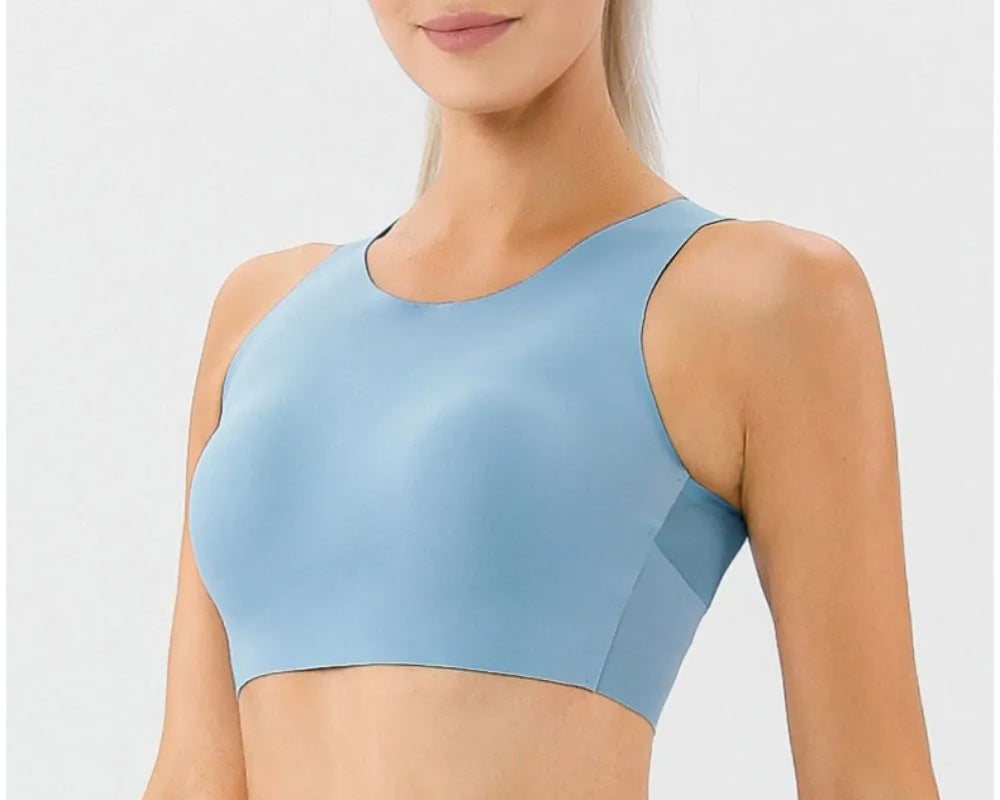 NEWYORKLISTED ACTIVEWEAR COLLECTION: Woman wearing a light blue sports bra and leggings on a white background