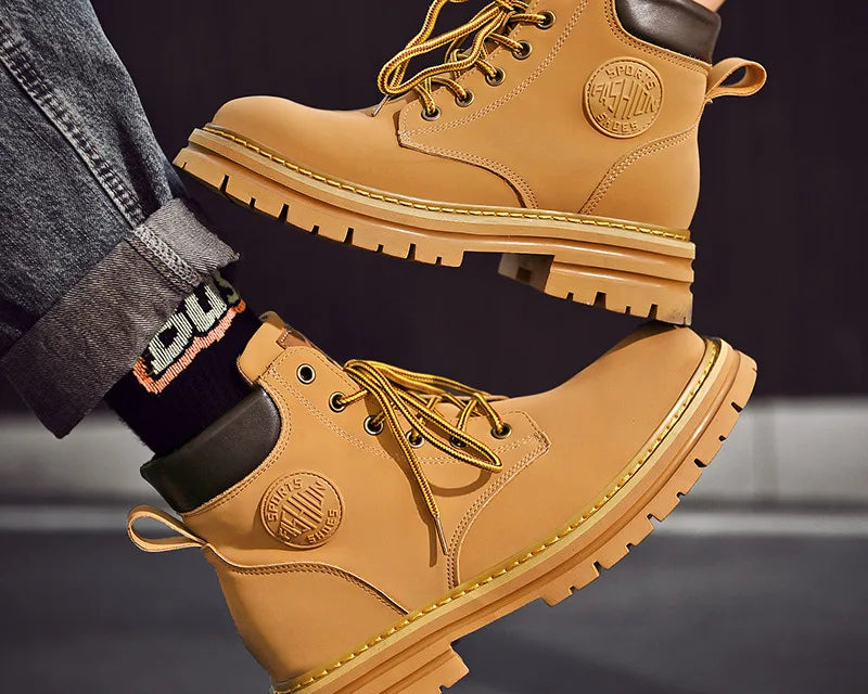 NEWYORKLISTED: Tan work boots with brand logo on a dark background