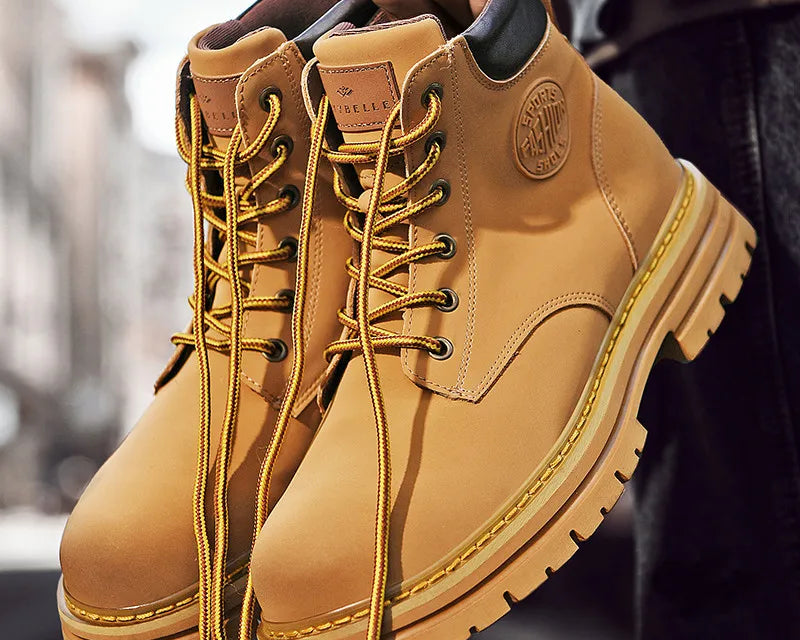 NEWYORKLISTED: Tan leather boots with laces held by a person against a blurred background