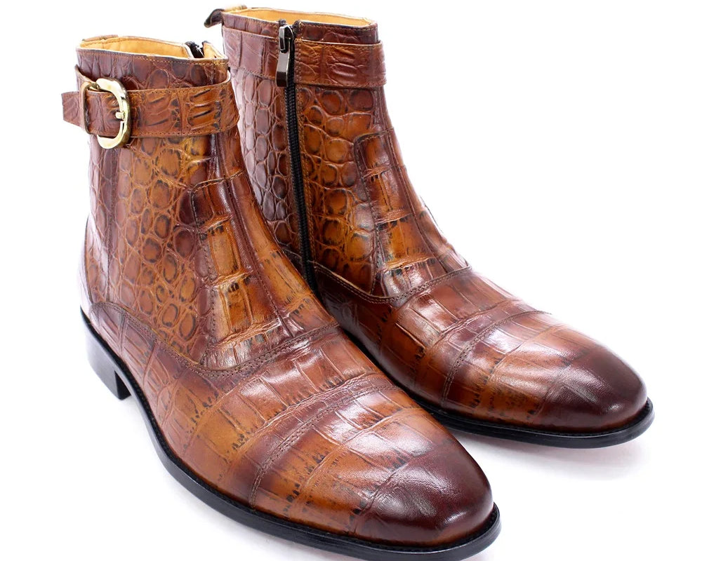 NEWYORKLISTED MEN'S COLLECTION: Pair of brown crocodile-patterned boots with gold buckle on a white background