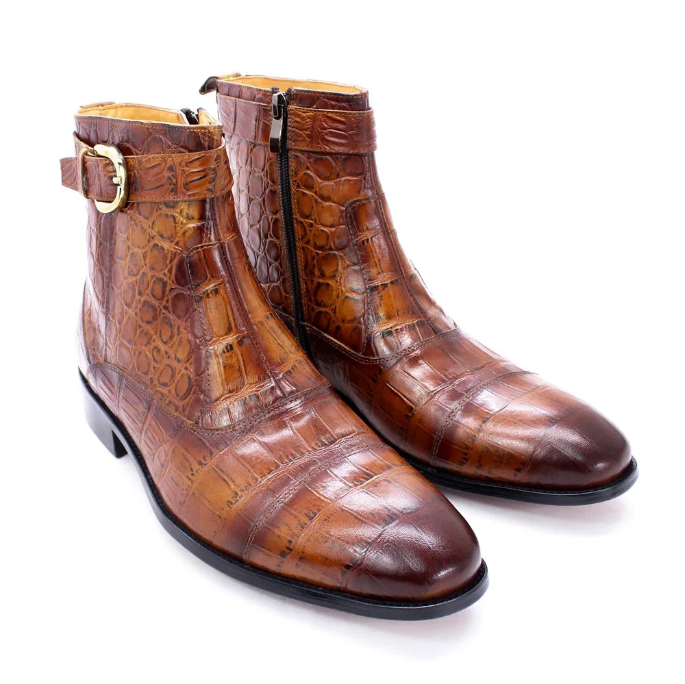 NEWYORKLISTED MEN'S COLLECTION: Pair of brown crocodile-patterned boots with gold buckle on a white background