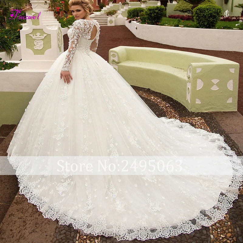 White lace wedding dress with long sleeves in an outdoor setting