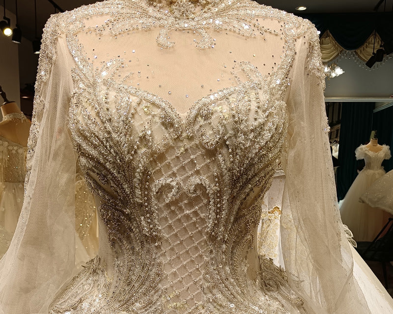 Elegant beaded gown on a mannequin with a blurred indoor background