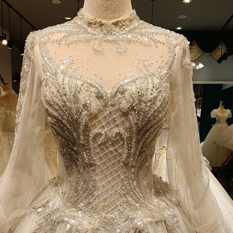 Elegant beaded gown on a mannequin with a blurred indoor background