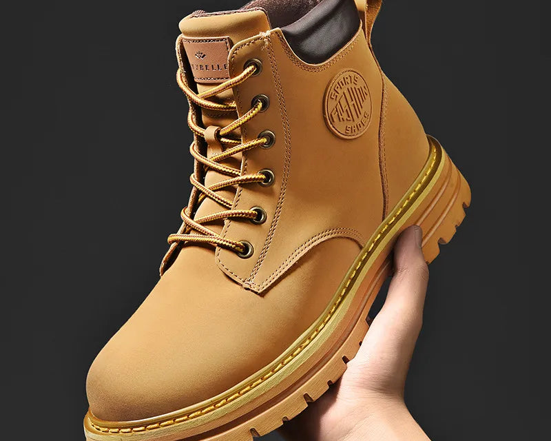 NEWYORKLISTED: Tan leather boot with brand logo held by a hand against a black background