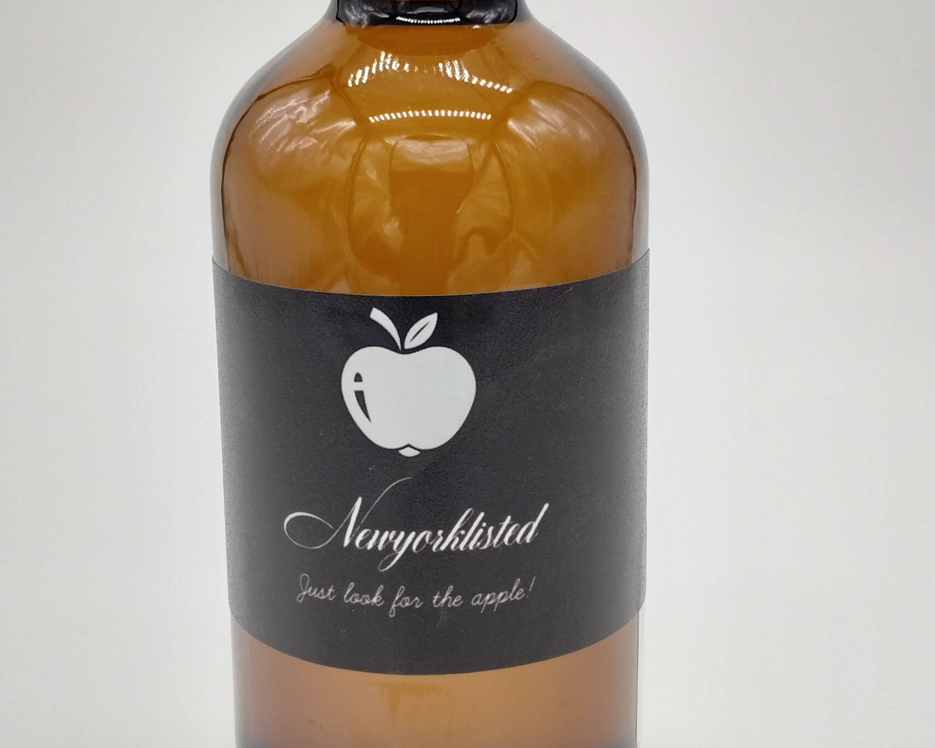 NEWYORKLISTED Organic Jamaican Black Castor Oil 8 oz amber glass bottle with front label and UPC, cold-pressed natural oil for hair growth and skin hydration.