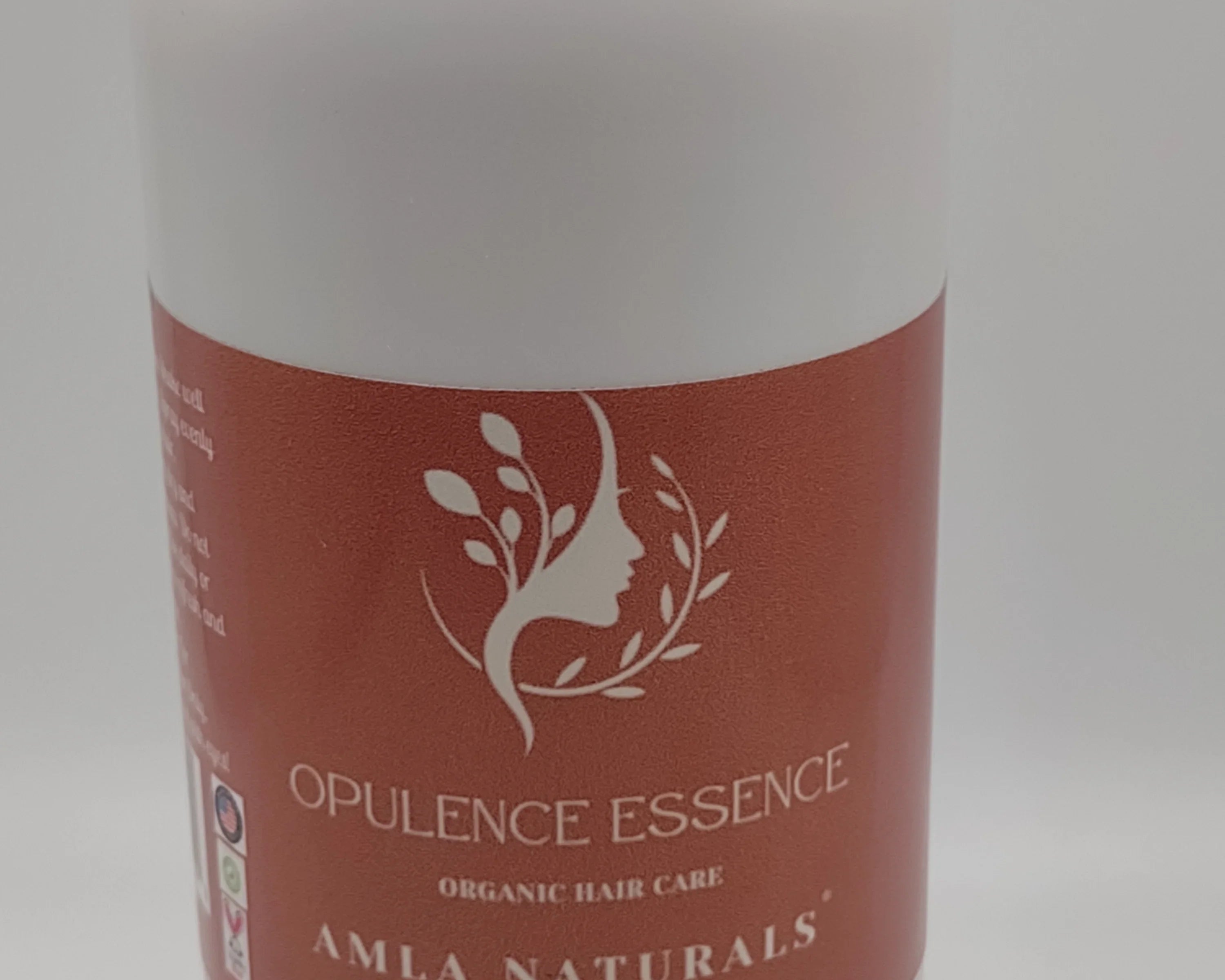 Opulence Essence bottle with red label on a white background: NEWYORKLSITED.COM
