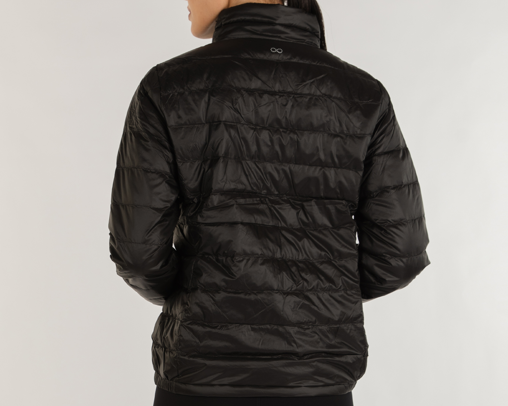 Person wearing a black puffer jacket on a white background