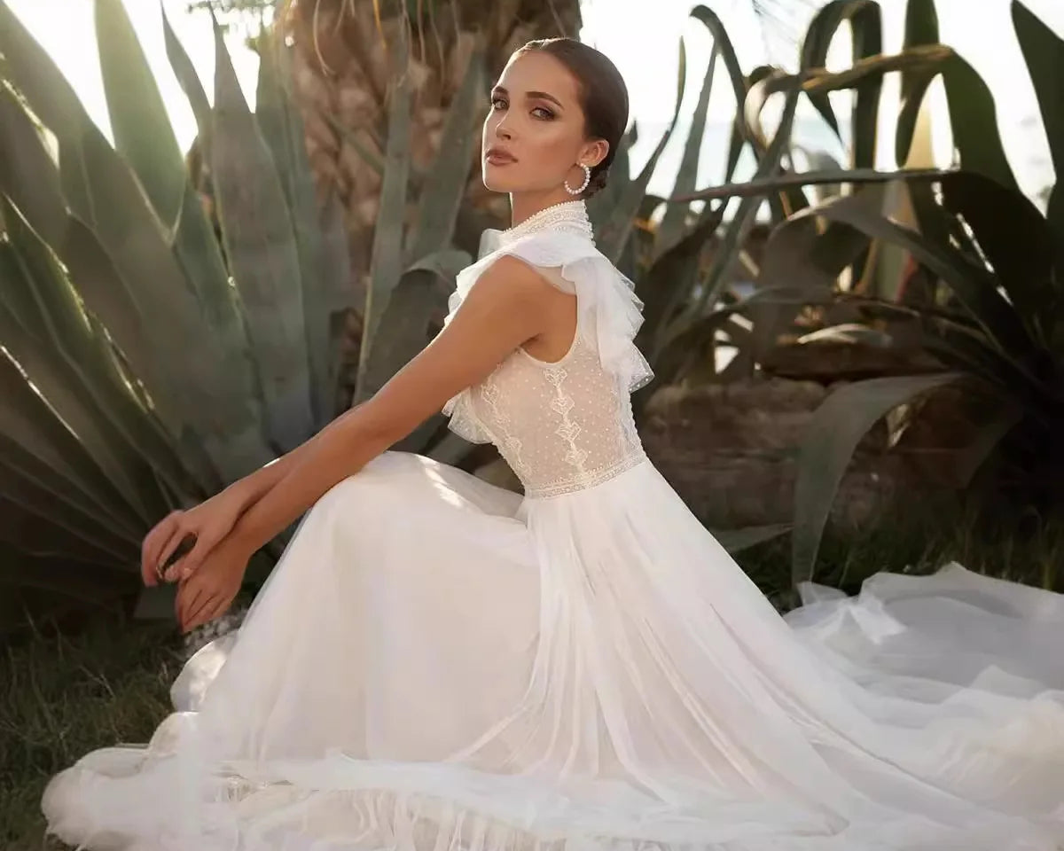 Woman in a white dress sitting among plants with a warm glow