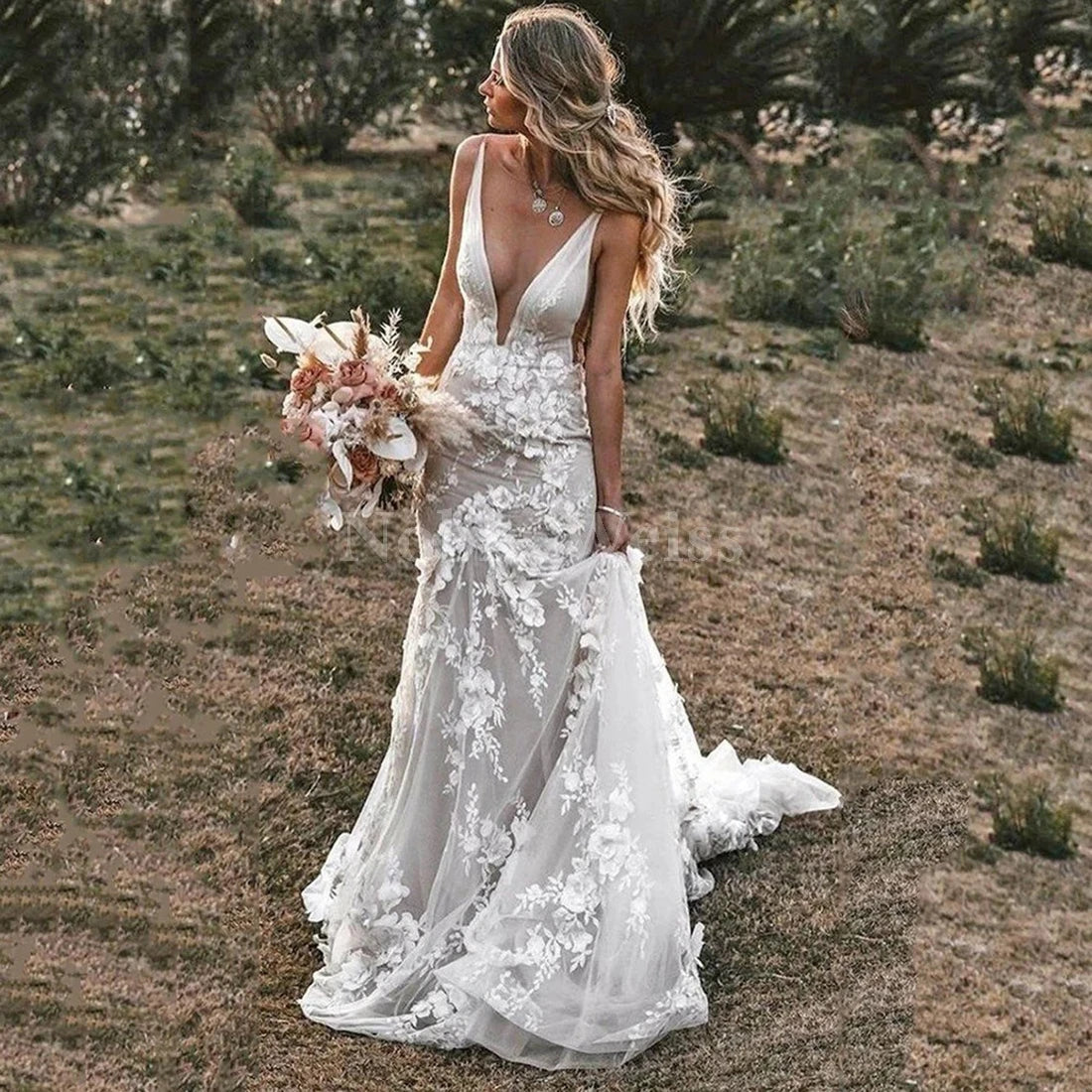 NEWYORKLISTED Elegant Bride Collection: Woman in a white lace wedding dress holding a bouquet in a desert setting