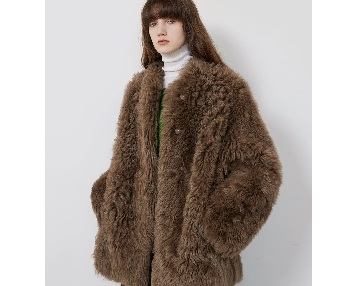 NEWYORKLISTED STYLE COLLECTION: Person wearing a brown fur coat on a white background