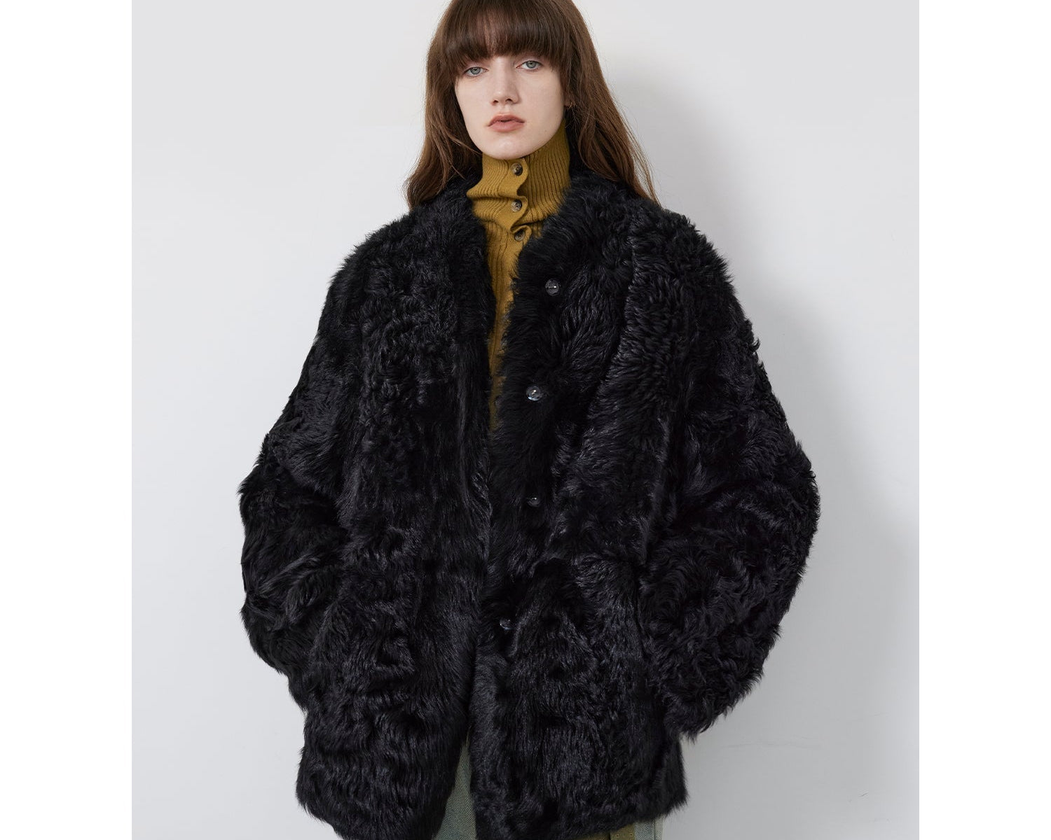 NEWYORKLSITED STYLE COLLECTION: Person wearing a black fluffy coat against a white background