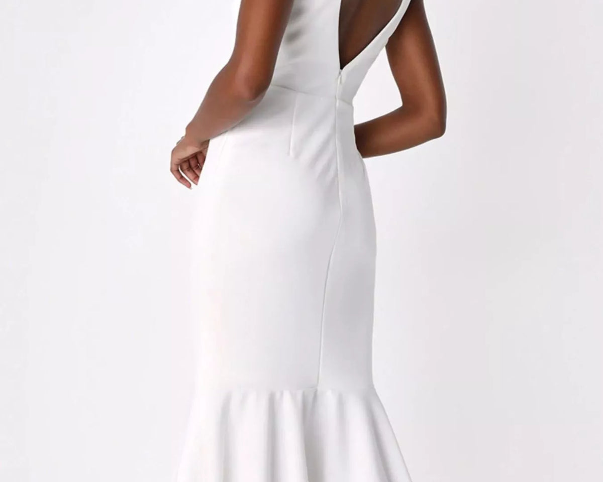 NEWYORKLISTED STYLE COLLECTION: A woman modeling a white sleeveless midi dress from the back, featuring a deep open back, fitted silhouette, and flared ruffled hem, set against a plain white studio background.