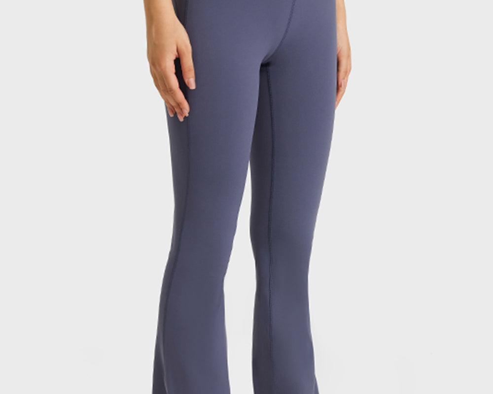 NEWYORKLISTED ACTIVEWEAR COLLECTION: Person wearing purple flared pants on a white background