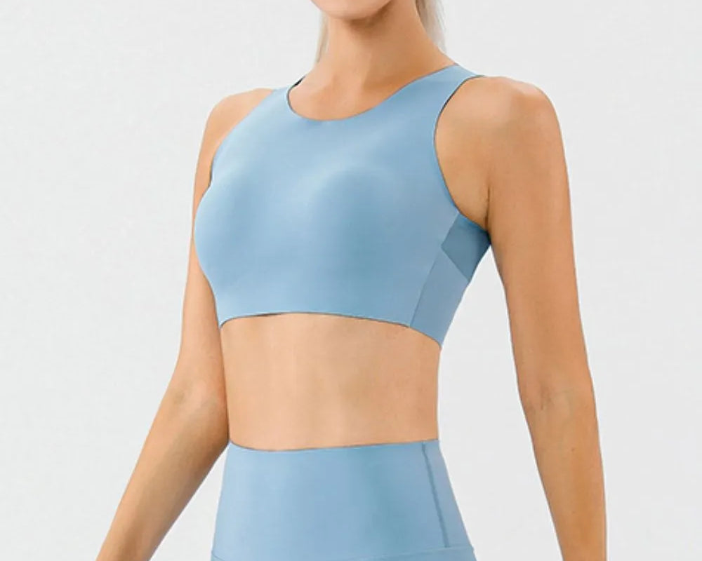 NEWYORKLISTED ACTIVEWEAR COLLECTION: Woman wearing a light blue athletic outfit on a white background