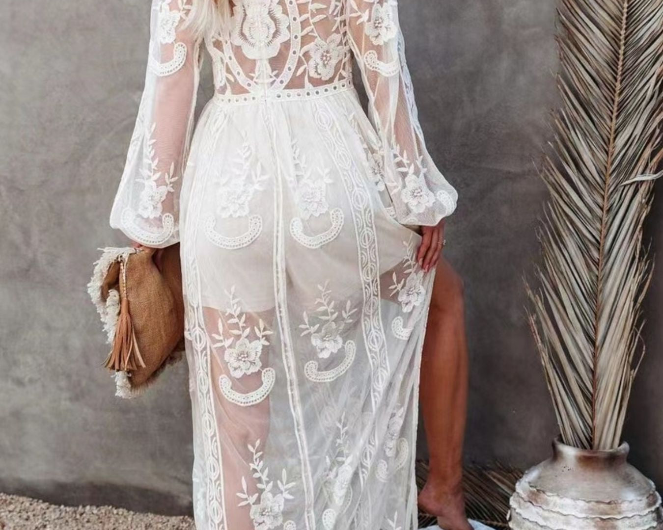 NEWYORKLISTED STYLE COLLECTION: Woman wearing a white lace dress with long sleeves in a natural setting.