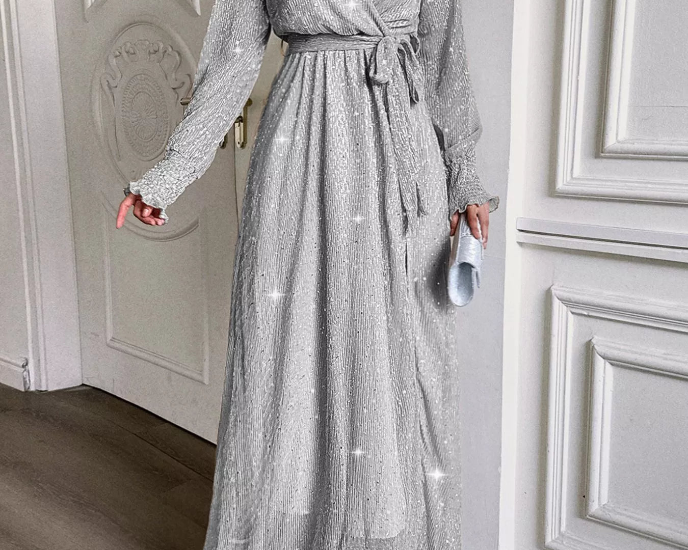 NEWYORKLISTED STYLE COLLECTION: Woman wearing a silver sequin dress in an elegant interior setting