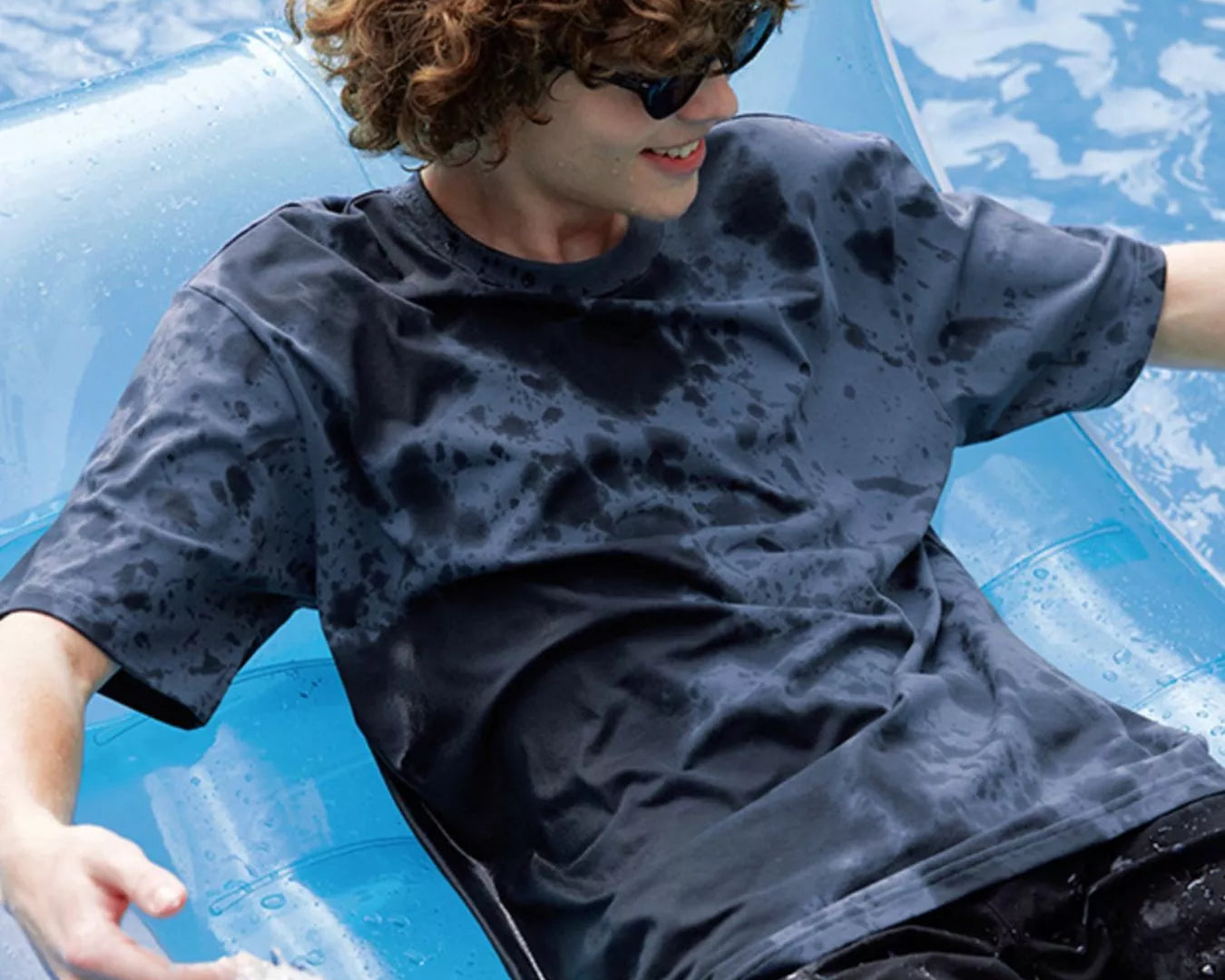 NEWYORKLISTED ATLAS MEN's COLLECTION: Person lounging on an inflatable pool float in a pool