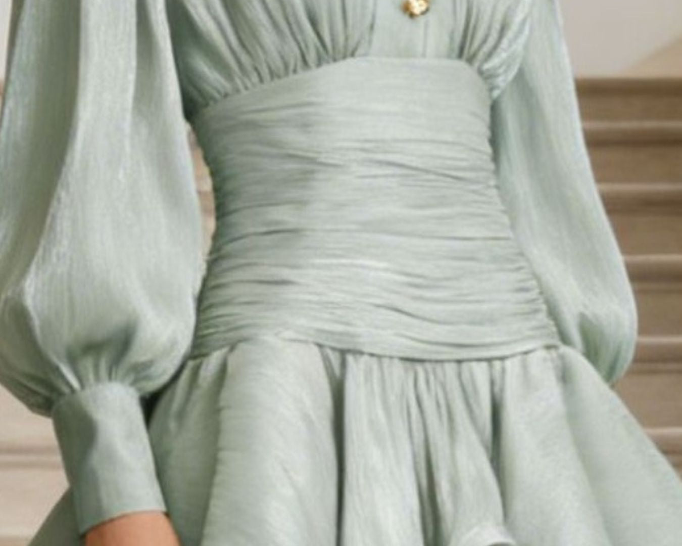 NEWYORKLISTED STYLE COLLECTION: Light green dress with gold buttons on a neutral background