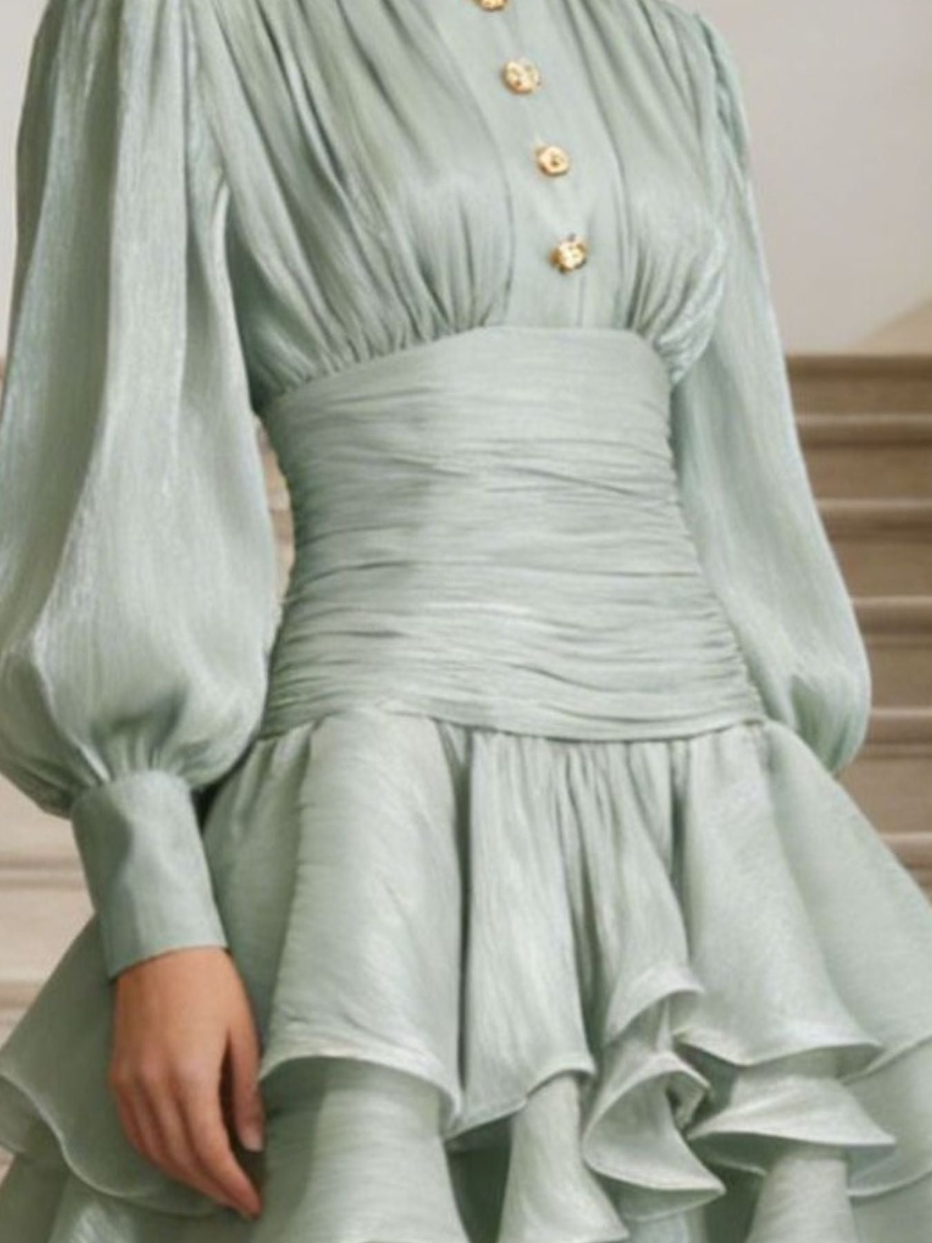 NEWYORKLISTED STYLE COLLECTION: Light green dress with gold buttons on a neutral background